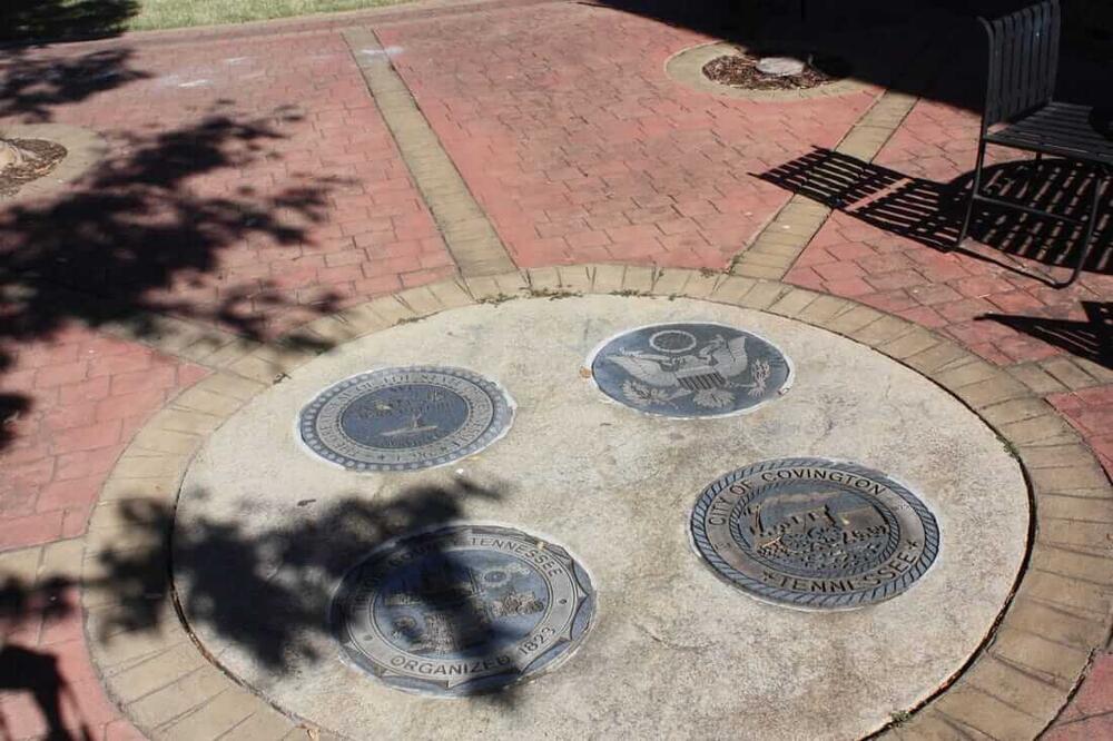several official seals engraved in cement at the park on the square