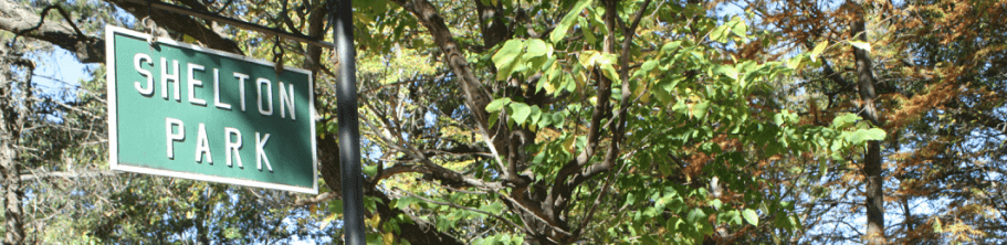 tree foliage and a sign that says Shelton Park