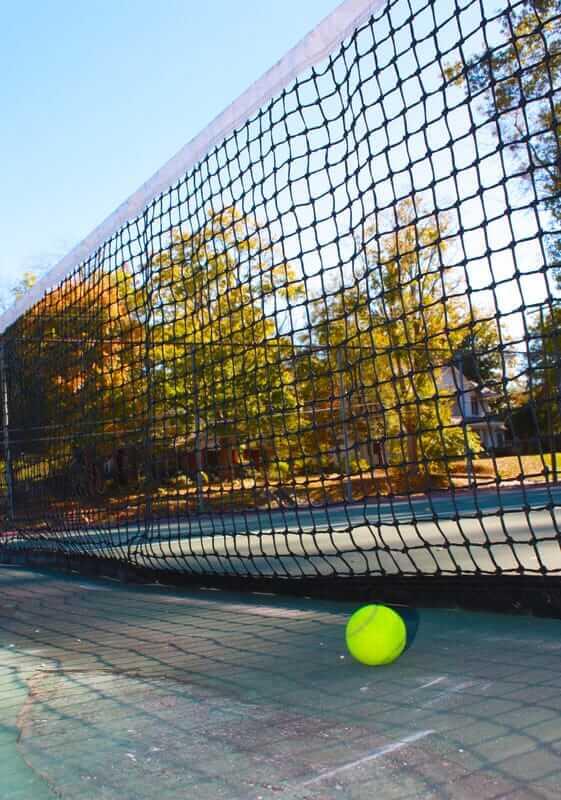 close up of a tennis net and tennis ball