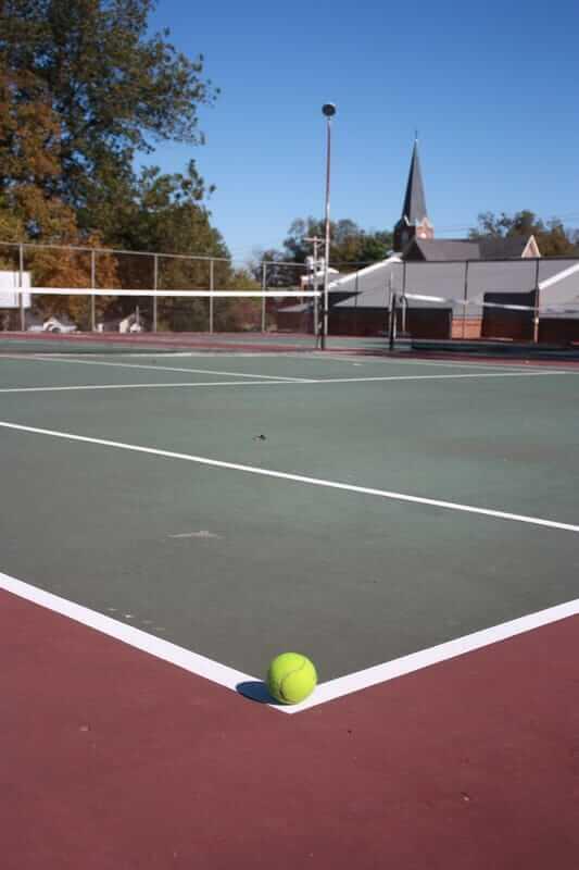 a tennis ball sitting on a clay surface court