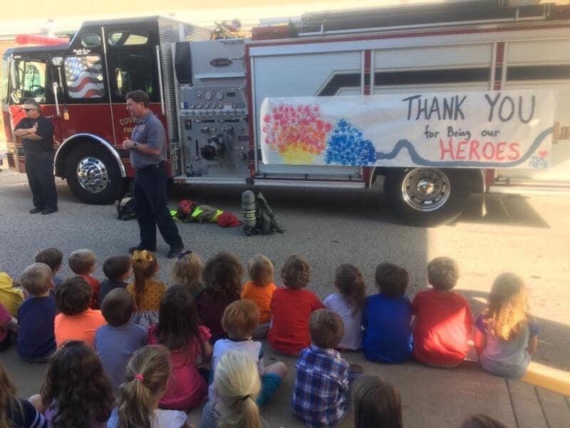 Covington fire department members speaking to a group of students