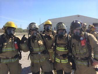 a group of firefighters in full uniform and gear