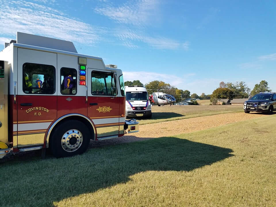 covington fire department truck and other emergency response vehicles at an accident scene