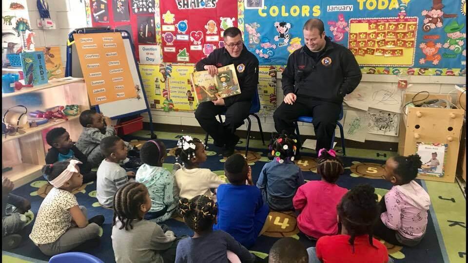 covington fire department members reading to students