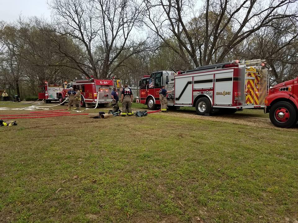 covington fire department members standing near tanker trucks