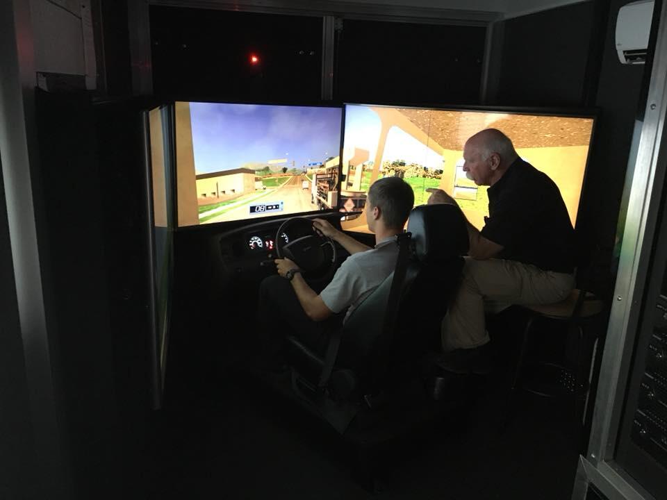 covington fire department member overseeing a student in a driving simulator