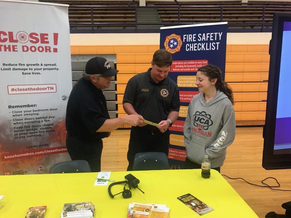 covington fire department members speaking to a female high school student
