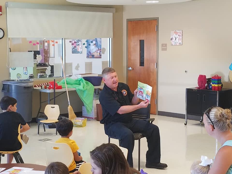 covington fire department member reading to students
