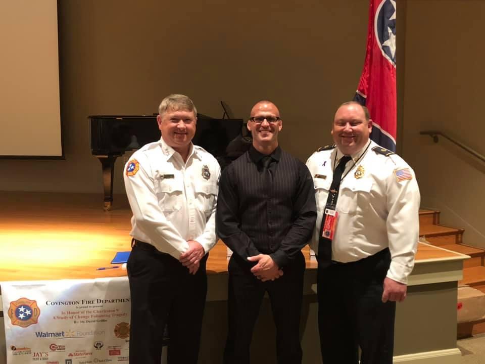covington fire department members and a community leader pose for a photo