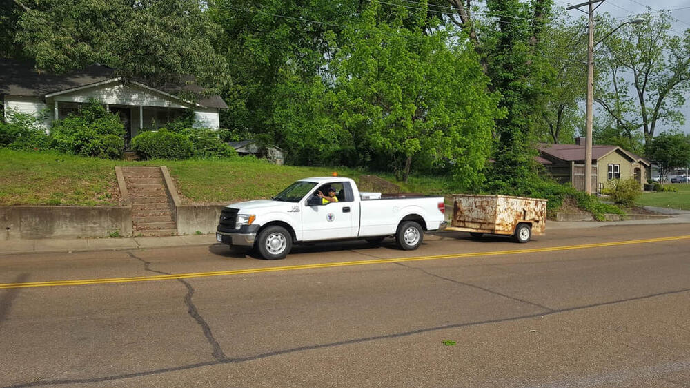 a street department truck pulling a trailer