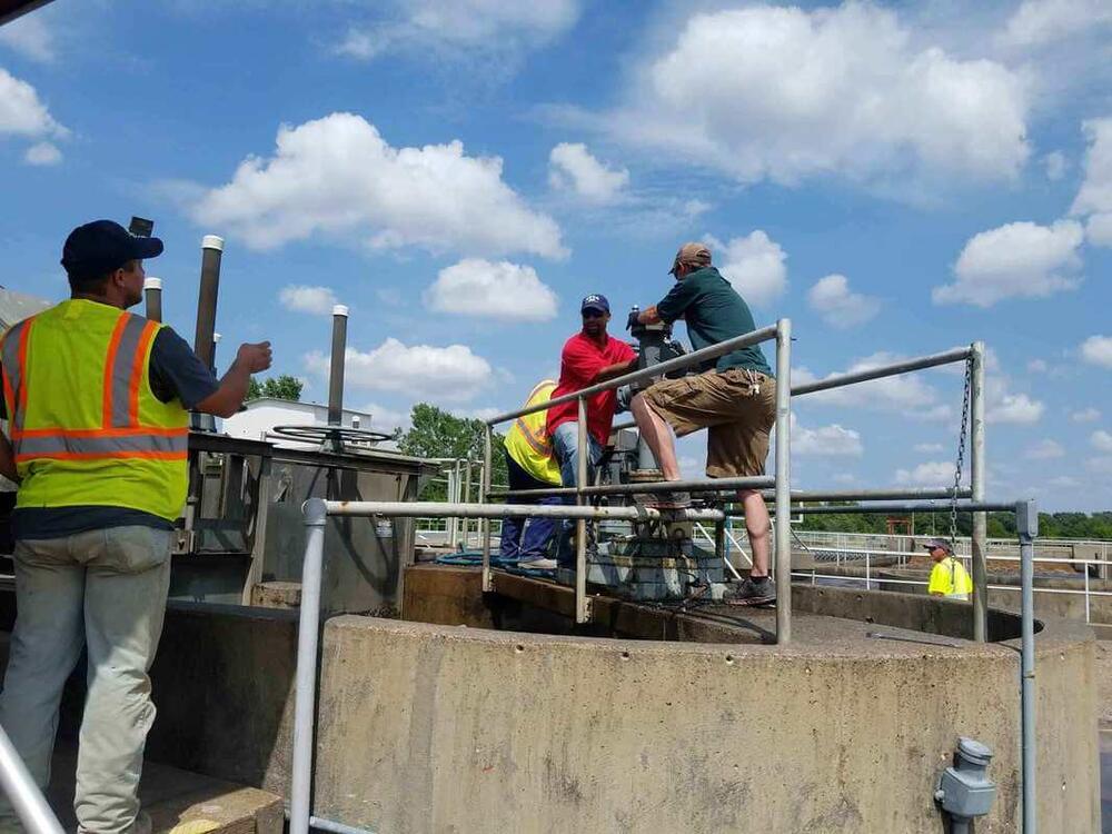 Covington Water and Sewer Department employees working at a waste water treatment facility
