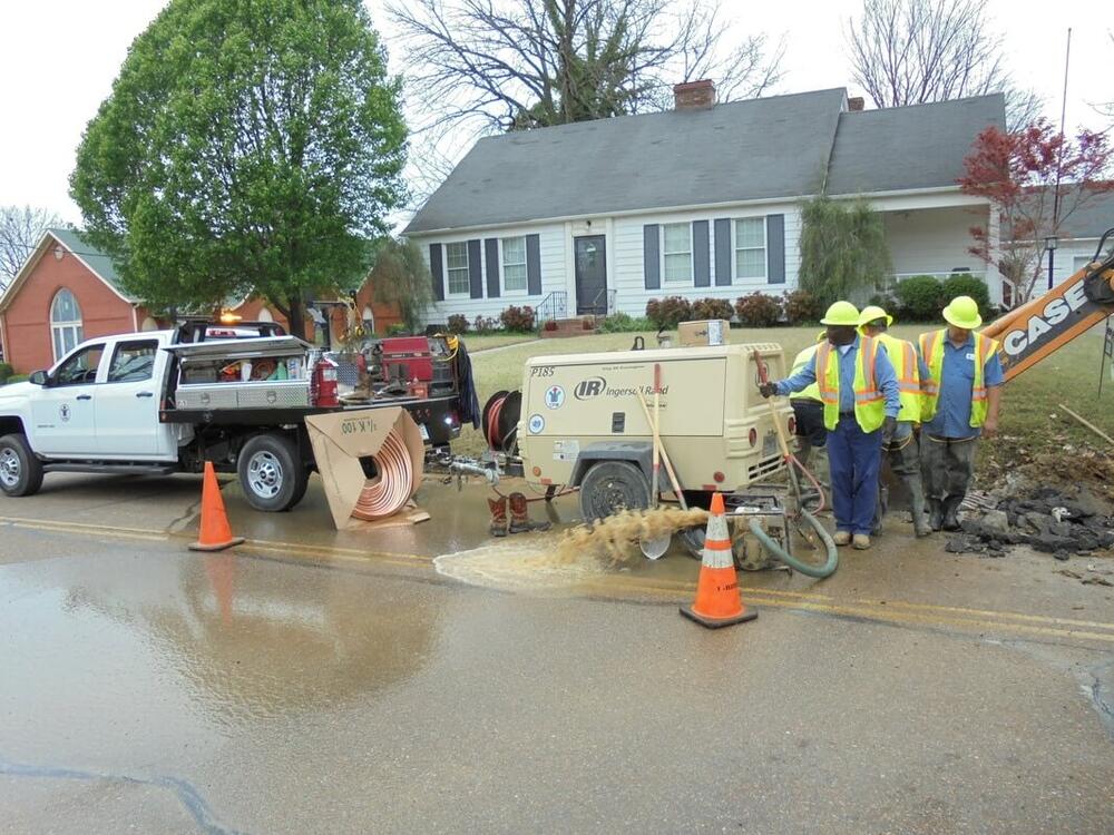 Covington Water and Sewer Department employees working on a water main