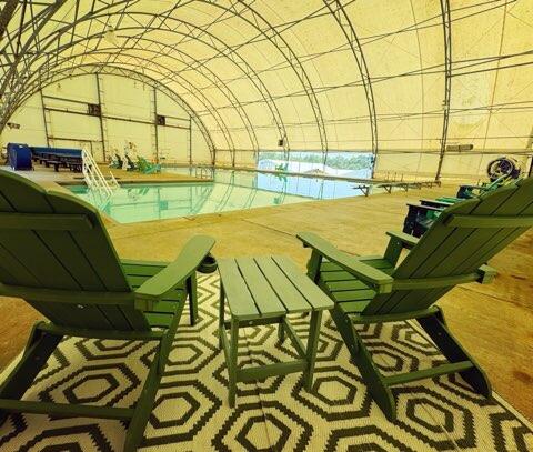 picture of 2 chairs inside pool area