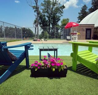 picture of 2 lounge chairs with kiddy pool in background