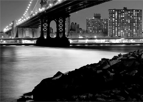 a river and bridge at night