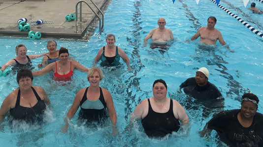 a group of water aerobics participants in a swimming pool