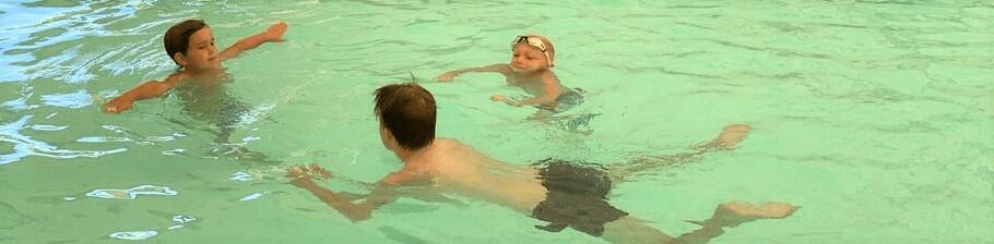 children taking swimming lessons