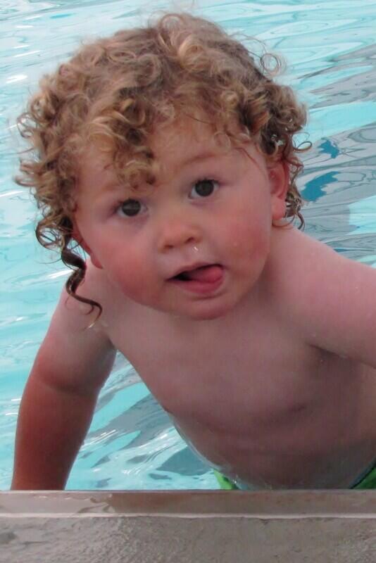 a toddler boy in a swimming pool